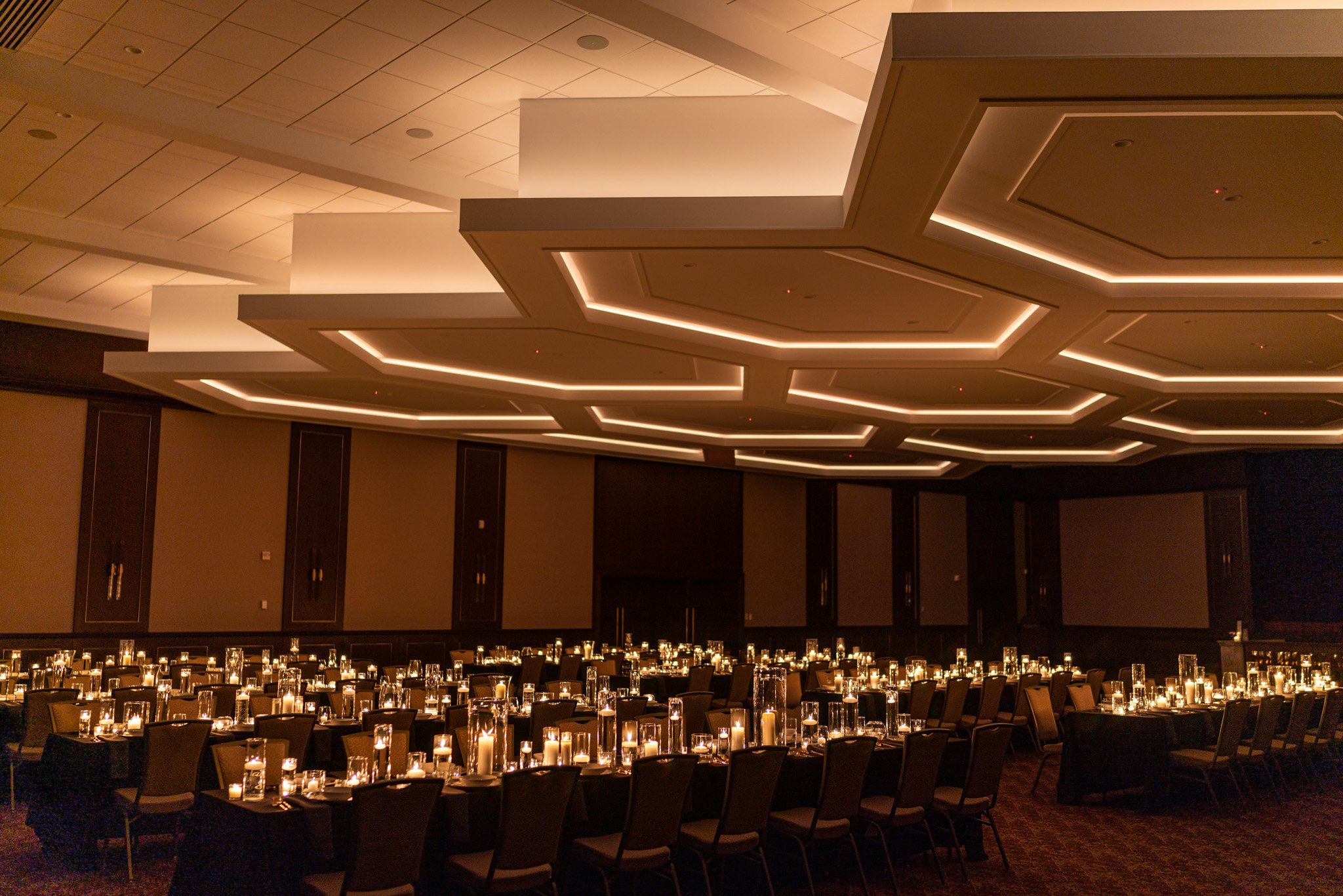 The Grand Ballroom — coffered hexagonal ceiling over hundreds of candlelit tables